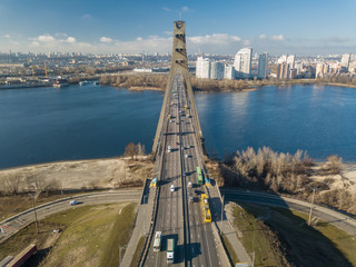 Aerial drone view. North bridge over the Dnieper river in Kiev in early spring on a sunny morning.