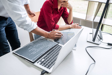 Wall Mural - two professional programmer cooperating and working on web site project in a software developing on 