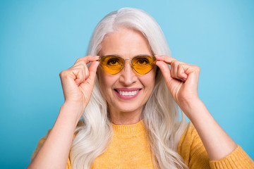 Close-up portrait of her she nice attractive lovely cool content cheerful cheery grey-haired woman wearing touching specs isolated over bright vivid shine vibrant blue color background