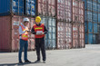 © think4photop - Foreman control loading containers box from cargo freight ship for import export, Foreman control industrial container cargo freight ship, Business import and export logistic concept.