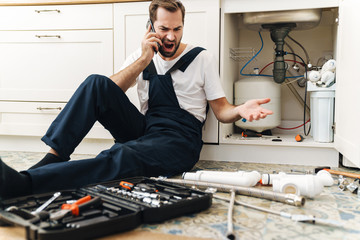 Sticker - Negative man plumber work in uniform indoors