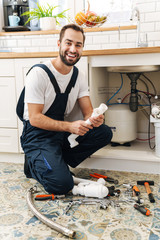 Plumber work in uniform indoors.