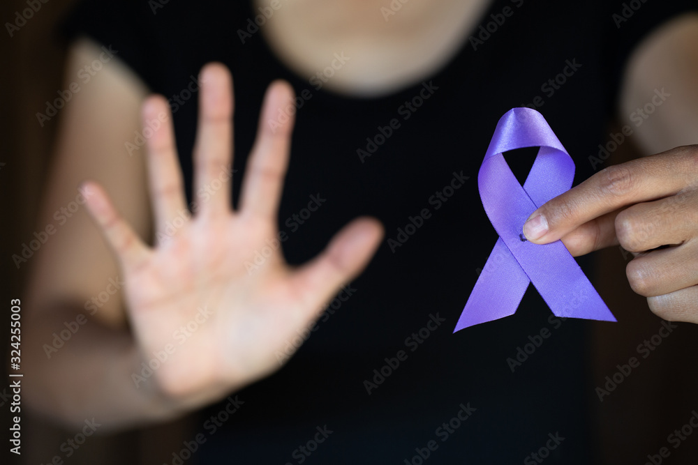 Purple ribbon in a woman's hand, Domestic Violence Awareness Month ...
