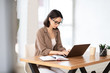 © Prostock-studio - Woman using her personal computer at home