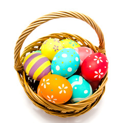 Colorful handmade painted easter eggs in the basket isolated