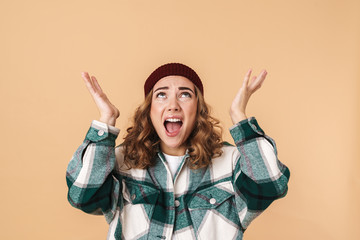 Poster - Photo of nervous young woman in knit hat screaming and looking upward