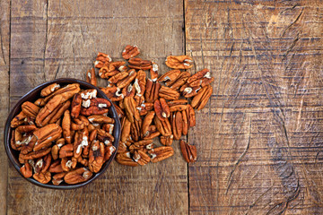 Wall Mural - Bowl with pecan on rustic wooden table