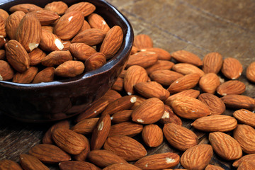 Wall Mural - Bowl with shelled almond on wooden table