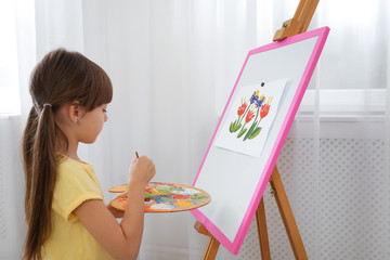 Sticker - Cute little child painting during lesson in room