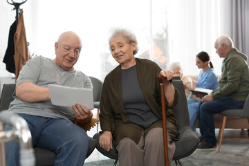 Canvas Print - Elderly people with tablet in geriatric hospice. Senior people care