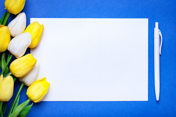 Wall Mural - bouquet of spring tulips on a bright background. greeting card. space for text.