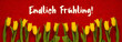 canvas print picture - Red Wooden Background With German Text Endlich Fruehling Means Finally Spring. Banner Of Yellow Tulip Flowers In Spring Season