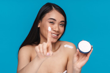 Woman holding moisture cream.