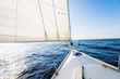 © Aastels - White yacht sails on a clear sunny day. A view from the deck to the bow and sails, close-up. Baltic sea, Latvia