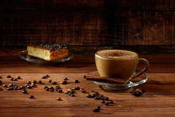 Wall Mural - Cup of coffe Cappuccino  with milk on a dark background. Hot coffe ,latte or Cappuccino prepared with milk on a wooden table with copy space.