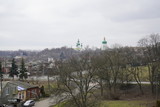 Fototapeta Na sufit - View of the domes of the church. City view, people walk around the city against the background of the church.