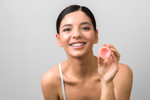 Lips Care And Protection. Smiling Beautiful Woman Holding A Jar Of Lip Balm