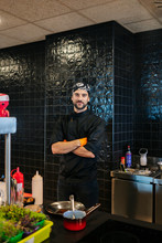 Portrait Of Confident Chef In Restaurant Kitchen