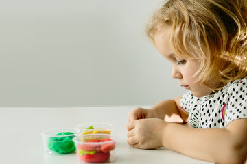 Wall Mural - the child is engaged in modeling on the table