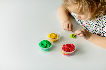 Wall Mural - the child is engaged in modeling on the table