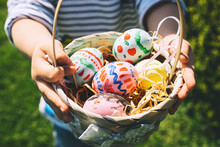 Colorful Easter Eggs In Basket. Kids Hunt For Eggs Outdoors.