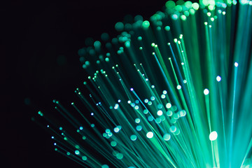 fiber optic abstract neon lights colorful background. close up view with bokeh. glowing optical fibe