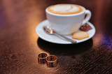 Fototapeta Mapy - Cup of coffee and wedding rings