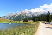 Mountain Alps Panorama Of Brenta Dolomites, Golf Course And Lake In Italy