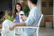 © Blue Jean Images - Young Chinese couple relaxing on balcony