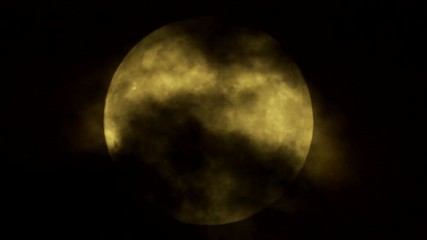 Wall Mural - Clouds cross the luminous disk of the moon