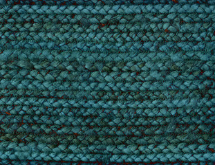 Textured background of a weaving in teal