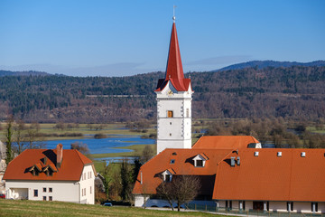 Wall Mural - Old Planina village with church and red roofs in Slovenia