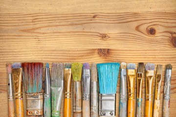 Sticker - A row of artist paint brushes on desk