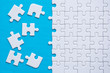 © gballgiggs - Jigsaw puzzle white color on blue color background copy space for text,Top view