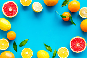 Wall Mural - Citrus fruits - lemons, grapefruits - on blue background mockup, frame top-down copy space