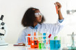 © Art_Photo - African american girl students learning and doing a chemical experiment and holding test tube in hands in science class on the table.Education concept
