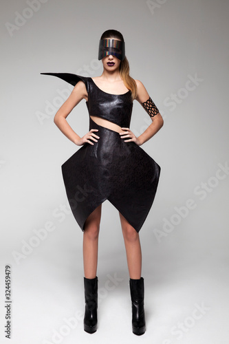 Cuadros en Lienzo brunette model in high fashion, detailed, black leather dress and futuristic holographic mask