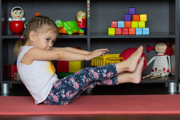 Wall Mural - Little girl making boat yoga pose as