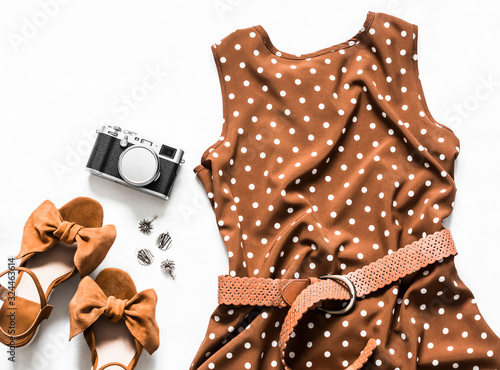 Cuadros en Lienzo Summer dress with polka dots without sleeves, suede wedge sandals, earrings, camera on a light background, top view