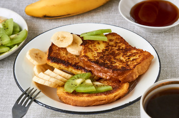 Wall Mural - French toasts with kiwi and banana on a gray background