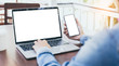 © panitan - mockup image blank screen computer,cell phone with white background for advertising text,hand woman using laptop texting mobile contact business search information on desk in office.marketing,design