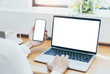 © panitan - mockup image blank screen computer,cell phone with white background for advertising text,hand woman using laptop texting mobile contact business search information on desk in office.marketing,design