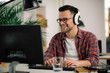 © JustLife - Businessman on video call. Handsome man in office with headphones.