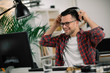 © JustLife - Businessman on video call. Handsome man in office with headphones.