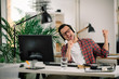 © JustLife - Attractive businessman in office. Young programmer with headphones singing at work.