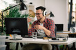© JustLife - Businessman on video call. Handsome man in office with headphones.