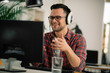 © JustLife - Businessman on video call. Handsome man in office with headphones.