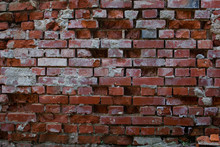 Old Broken, Damaged And Corroded Brick Wall With Broken Bricks Missing And Leaving Holes In The Wall For Background Or Wallpaper