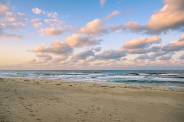Wall Mural - Colorful sky with clouds on the sea with beach