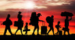 Crowd people migration at sunrise. Silhouette vector illustration (Clipping mask)